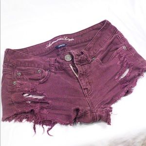 American Eagle burgundy ripped jean shorts.